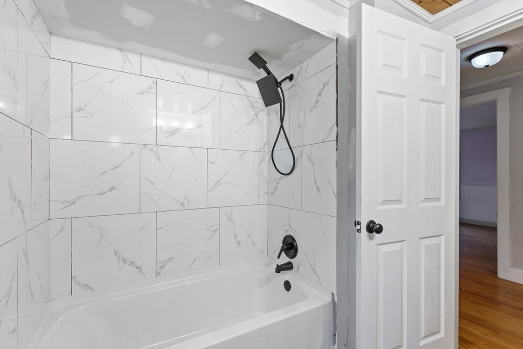 220 Pelham Street Methuen, MA 01844 - Photo 4 of 19 a bathroom with a bathtub