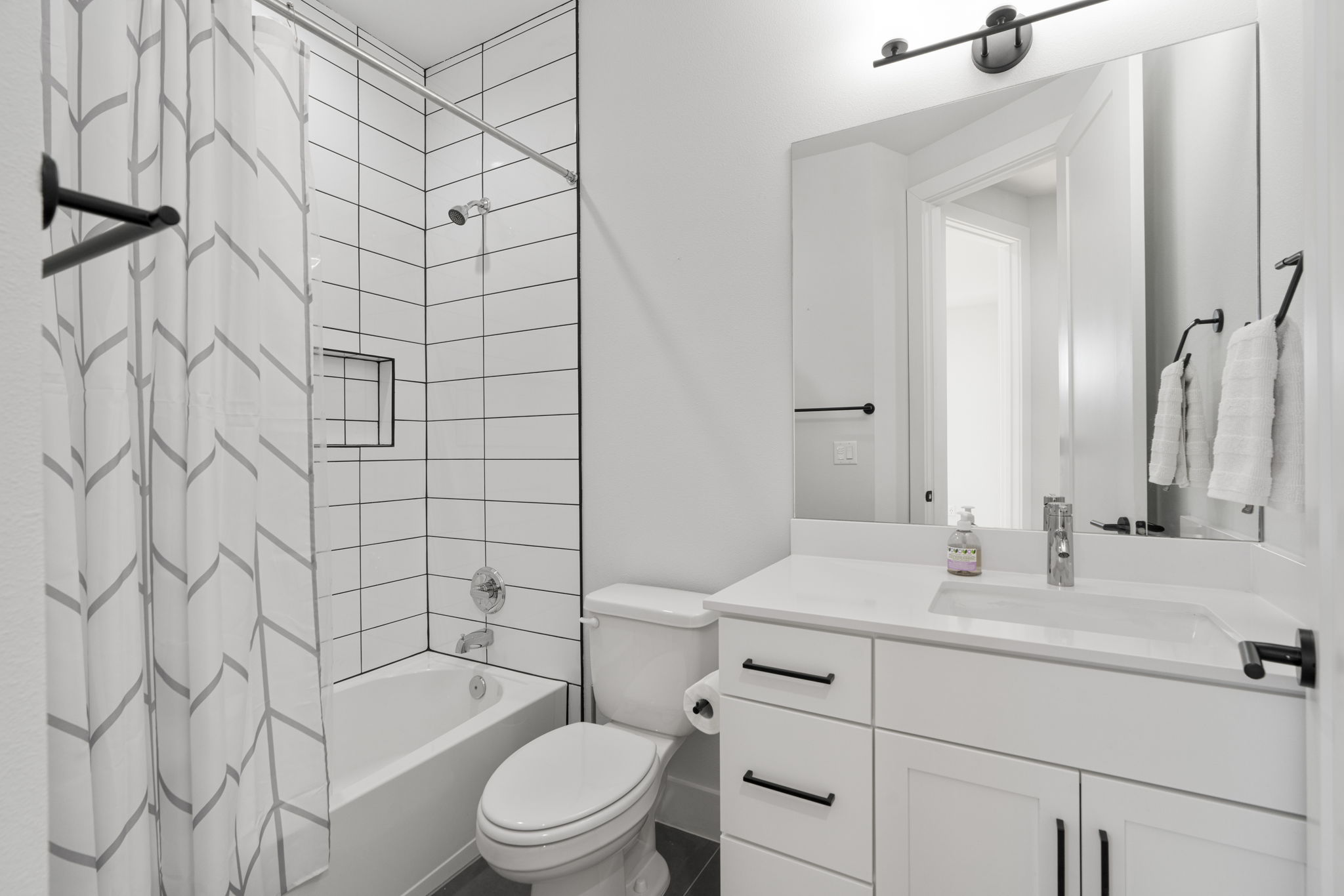 1405 Perez Street, Unit 1 Austin, TX 78721 - Photo 20 of 31 a bathroom with a sink mirror vanity and toilet