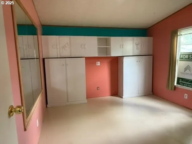 a view of a room with a hallway and stairs