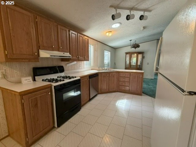 1401 West Ellendale Avenue, Unit 9 Dallas, OR 97338 - Photo 18 of 34 a kitchen with stainless steel appliances granite countertop a stove a sink and a refrigerator