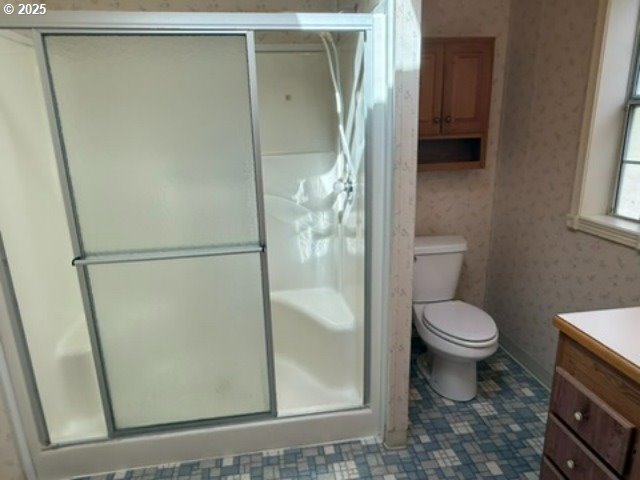 1401 West Ellendale Avenue, Unit 9 Dallas, OR 97338 - Photo 28 of 34 a bathroom with a granite countertop toilet and a shower