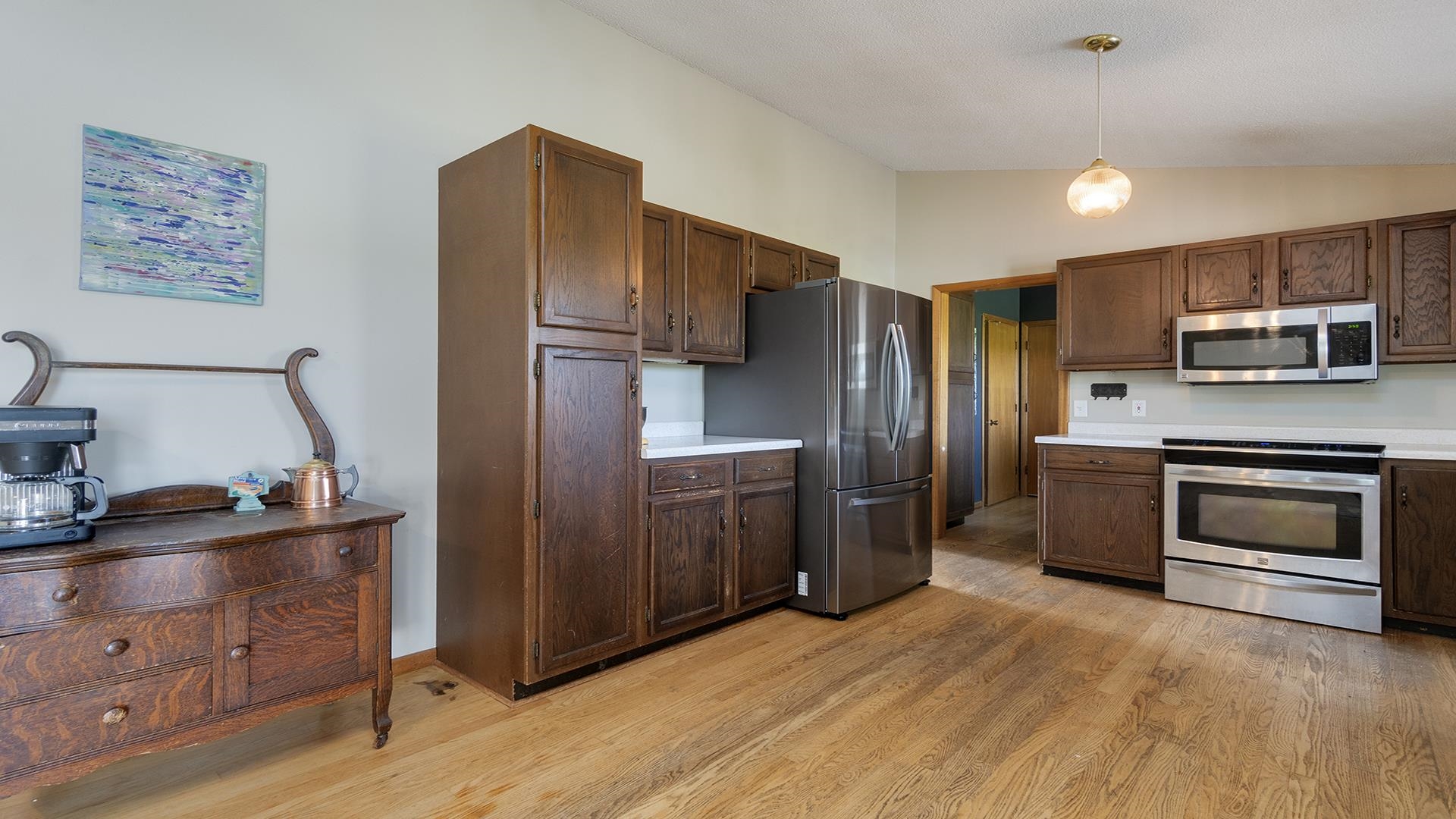 9807 North Leaf River Road Leaf River, IL 61047 - Photo 12 of 37 a kitchen with stainless steel appliances granite countertop a refrigerator microwave and sink