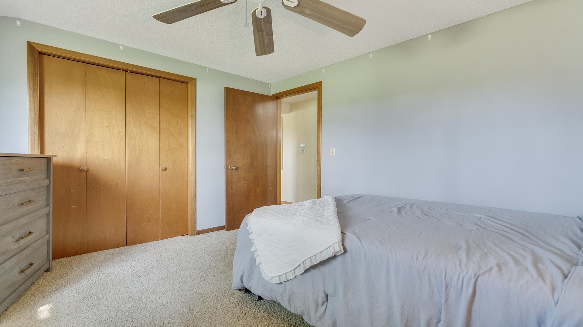 9807 North Leaf River Road Leaf River, IL 61047 - Photo 18 of 37 a bedroom with a bed and a cabinet