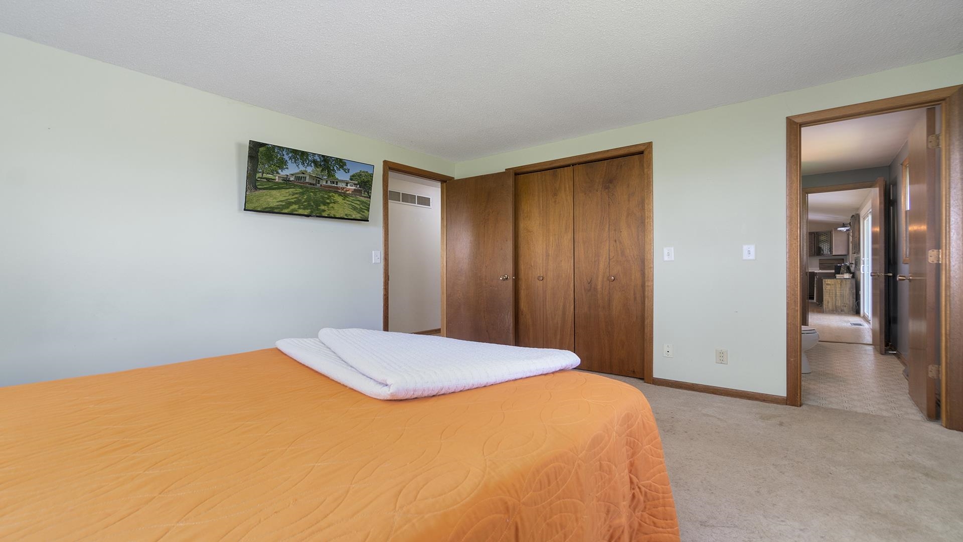 9807 North Leaf River Road Leaf River, IL 61047 - Photo 21 of 37 a bedroom with a bed and a painting on the wall