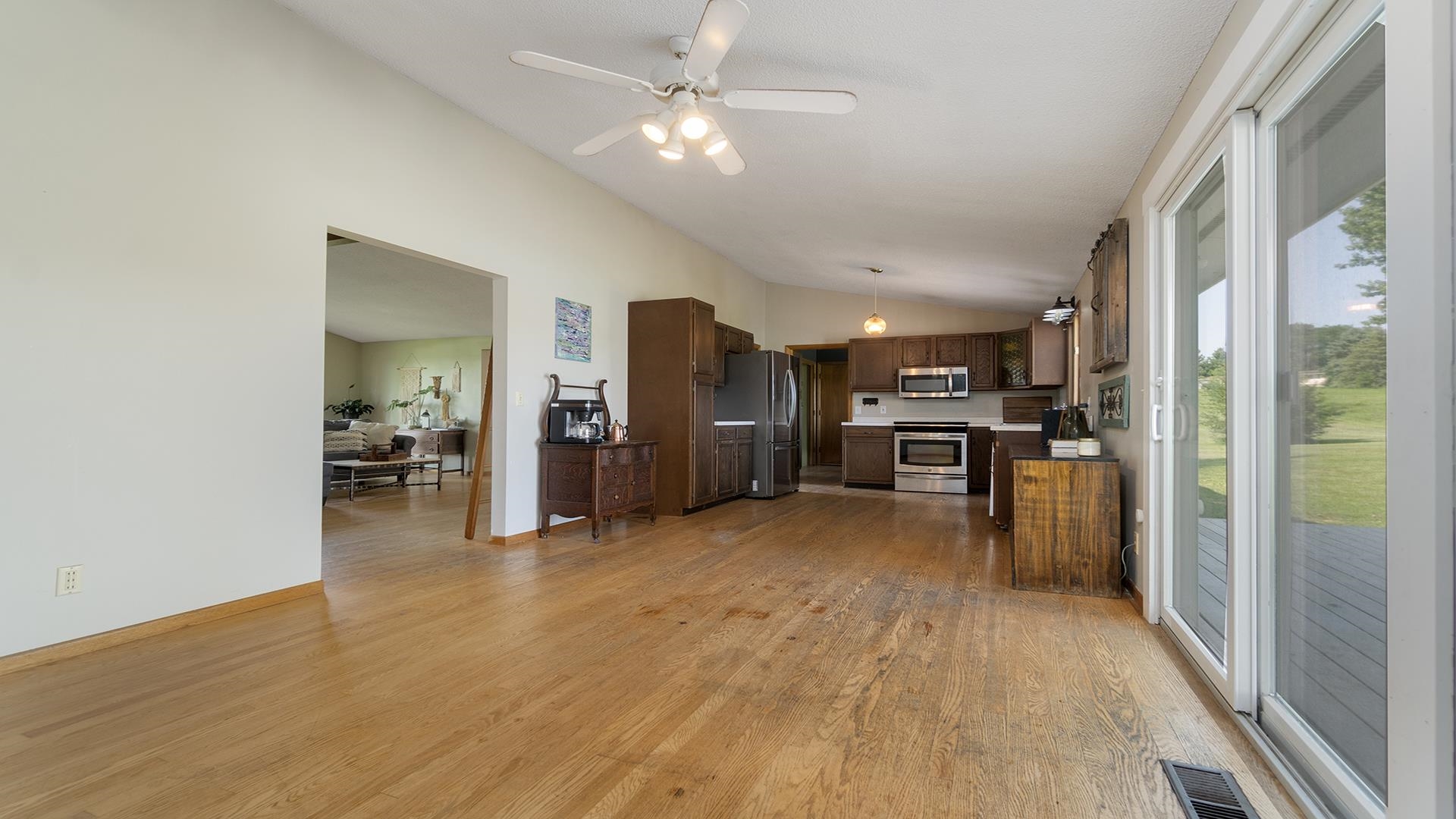 9807 North Leaf River Road Leaf River, IL 61047 - Photo 10 of 37 a view of a kitchen with refrigerator and a stove top oven
