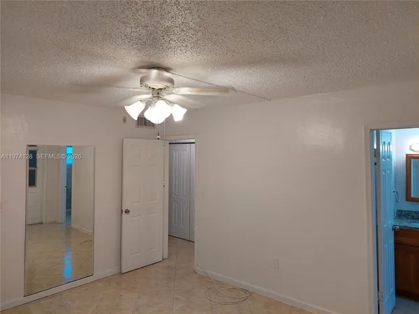 a room with a chair and glass door