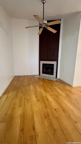 a view of empty room with a fireplace