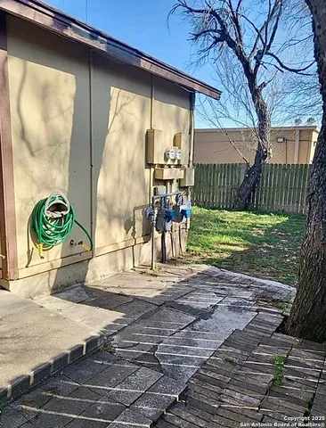 a view of a porch with a table and chairs