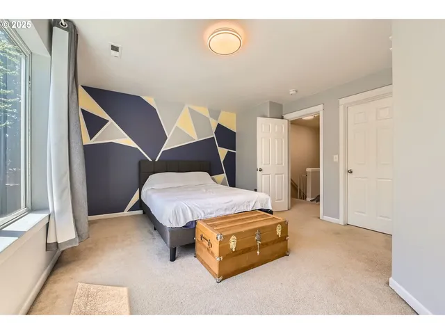 a bedroom with a bed and a desk