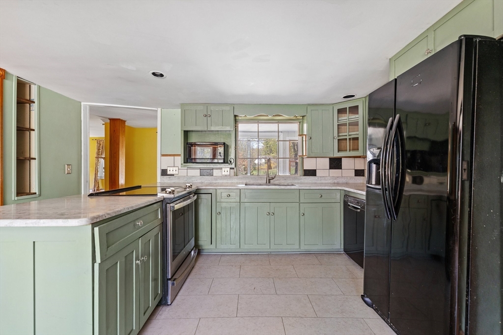 189 Fitchburg Road Ashburnham, MA 01430 - Photo 12 of 42 a kitchen with a sink refrigerator and window