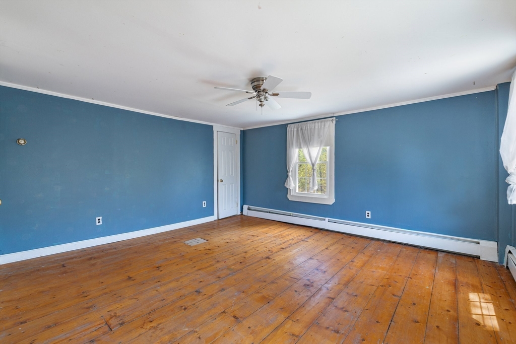 189 Fitchburg Road Ashburnham, MA 01430 - Photo 28 of 42 a view of an empty room with window and wooden floor