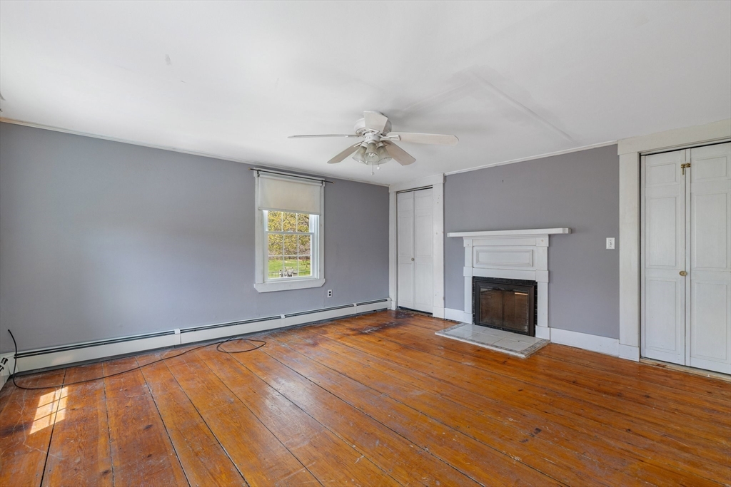 189 Fitchburg Road Ashburnham, MA 01430 - Photo 30 of 42 a view of an empty room with a fireplace and a window