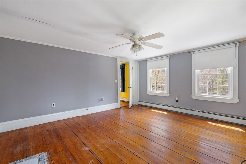 189 Fitchburg Road Ashburnham, MA 01430 - Photo 31 of 42 a view of an empty room with window and wooden floor