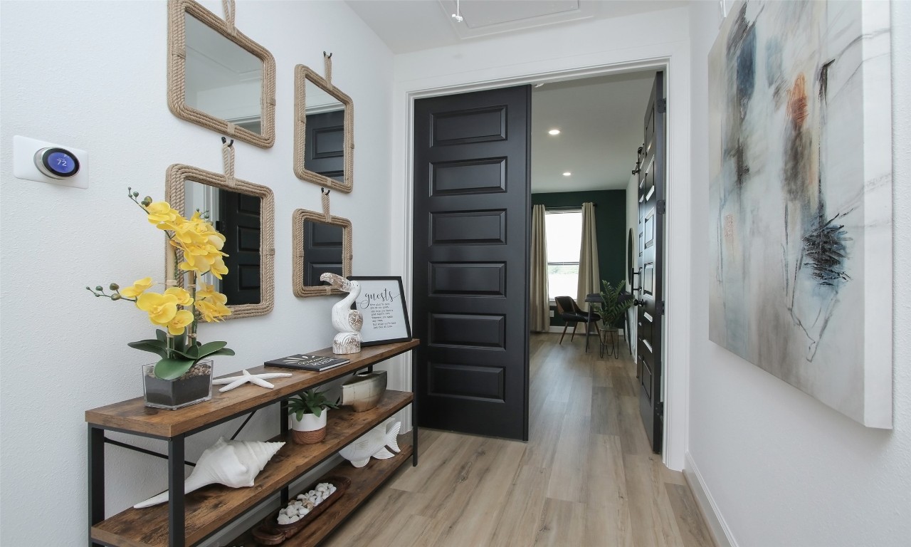 1817 Todville Road Seabrook, TX 77586 - Photo 15 of 27 a hallway with a potted plant on the table and a mirror