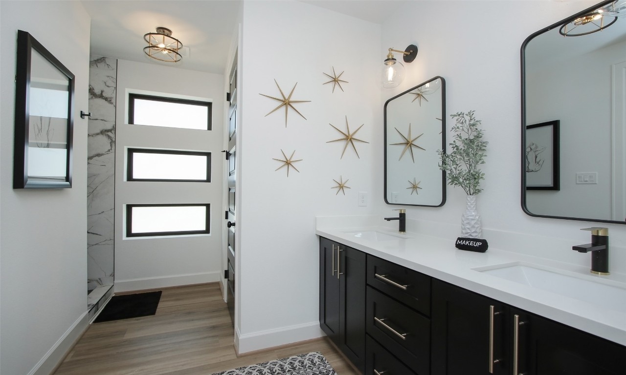 1817 Todville Road Seabrook, TX 77586 - Photo 7 of 27 a bathroom with a double vanity sink a mirror and shower