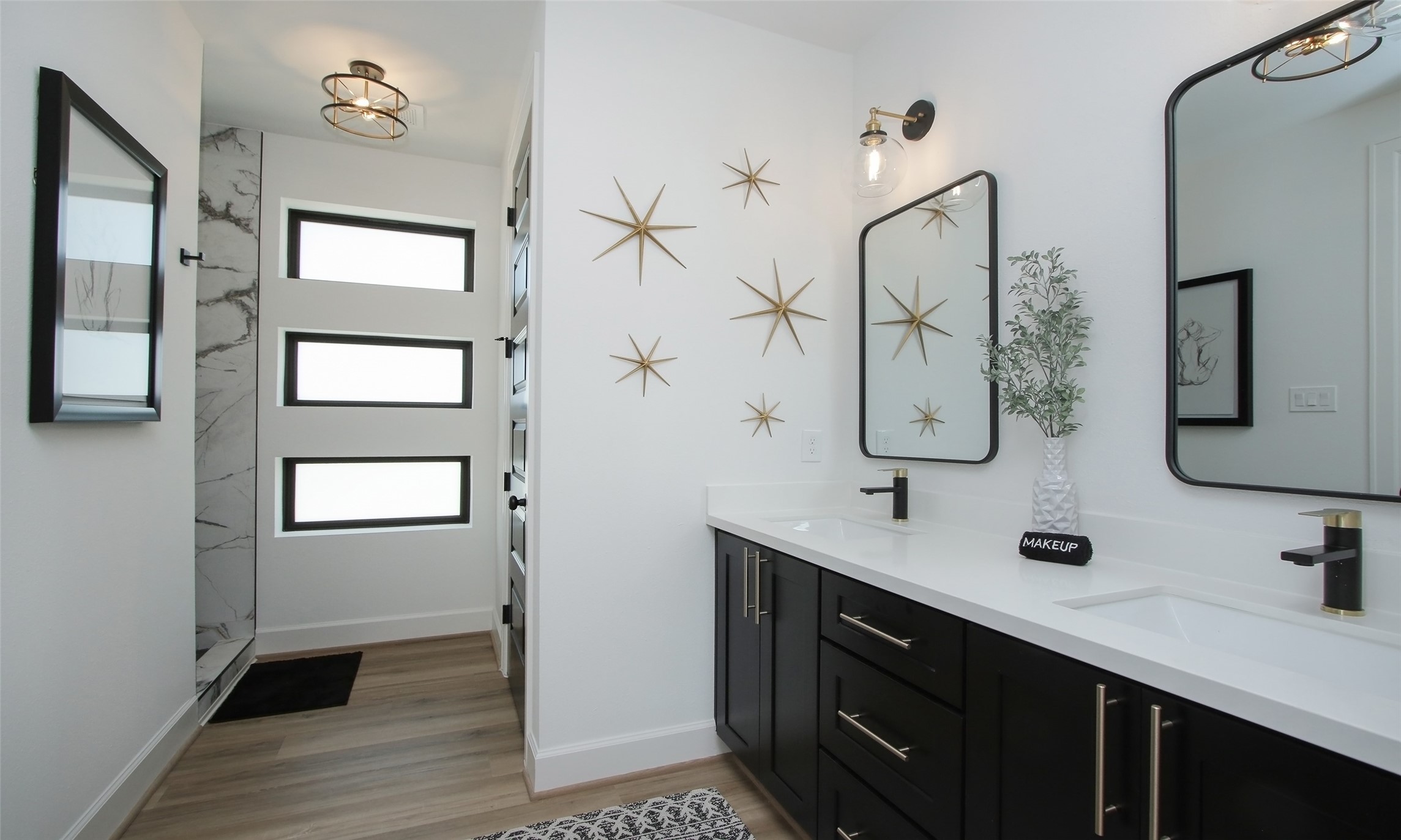 1817 Todville Road Seabrook, TX 77586 - Photo 7 of 27 a bathroom with a double vanity sink a mirror and shower