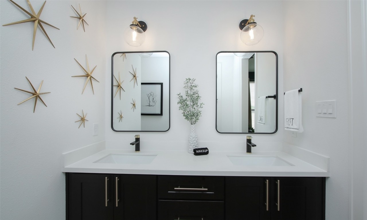 1817 Todville Road Seabrook, TX 77586 - Photo 8 of 27 a bathroom with double vanity sinks and a mirror