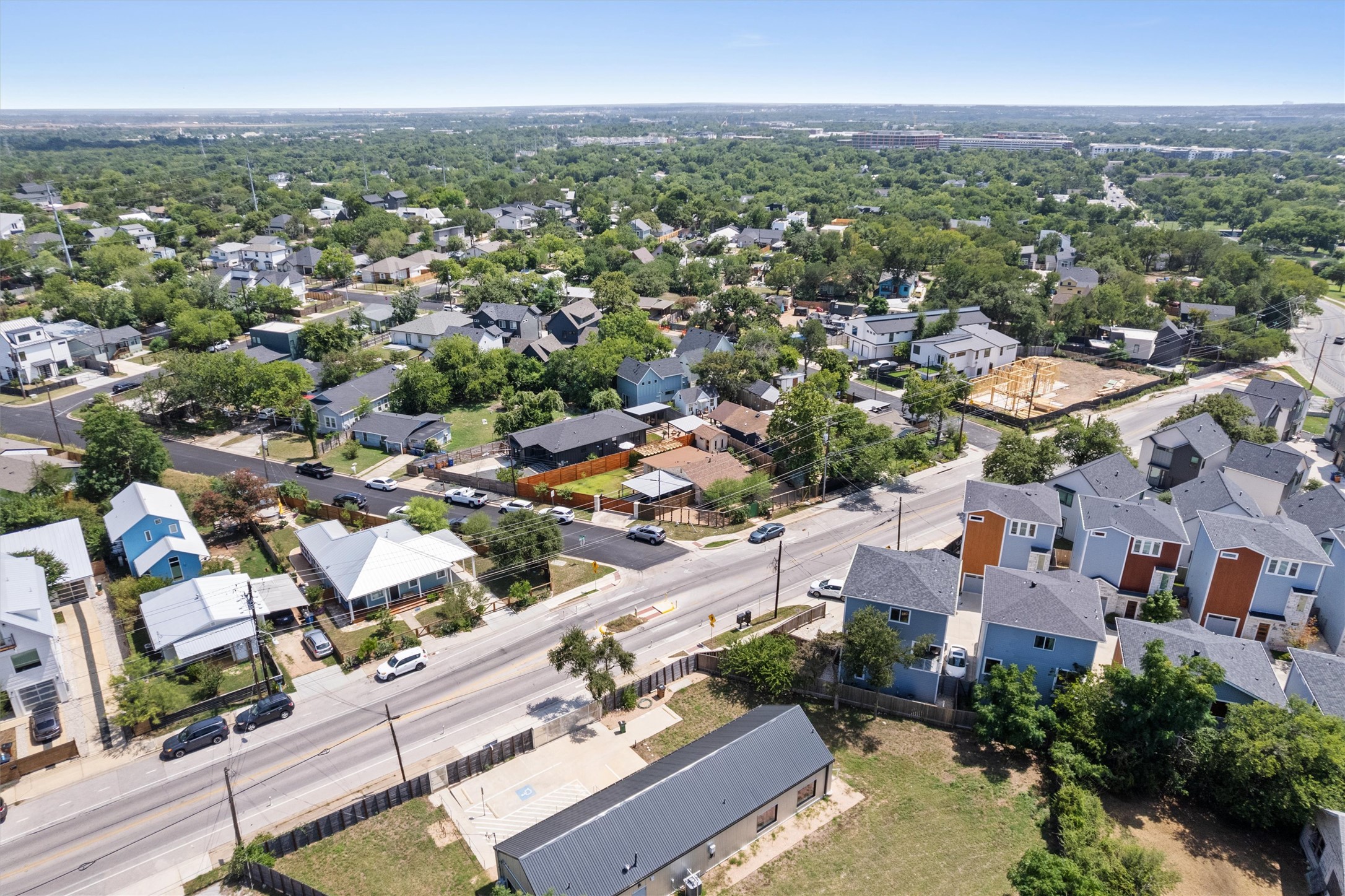 1147 Webberville Road Austin, TX 78721 - Photo 36 of 37 An aerial perspective reveals a vibrant neighborhood with diverse homes and abundant mature trees, creating a serene environment.