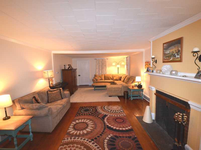 5926 Heckert Road Bakerstown, PA 15007 - Photo 2 of 24 Living Room. Large living room with warm rich wood floors, crown molding, log burning fireplace, built-in bookcases.