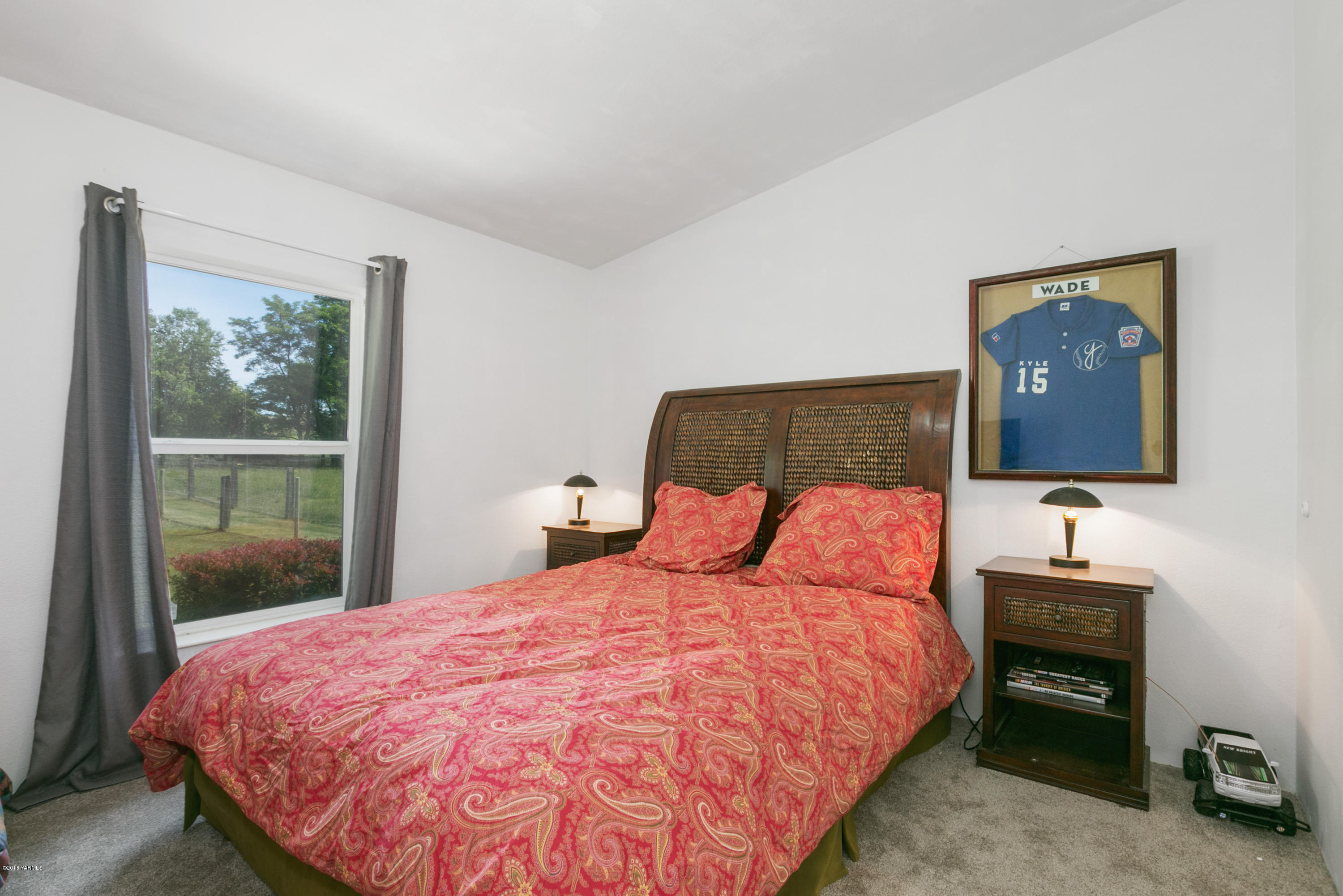 22490 Ahtanum Road Yakima, WA 98903 - Photo 11 of 20 a bedroom with a bed and a dresser next to a window