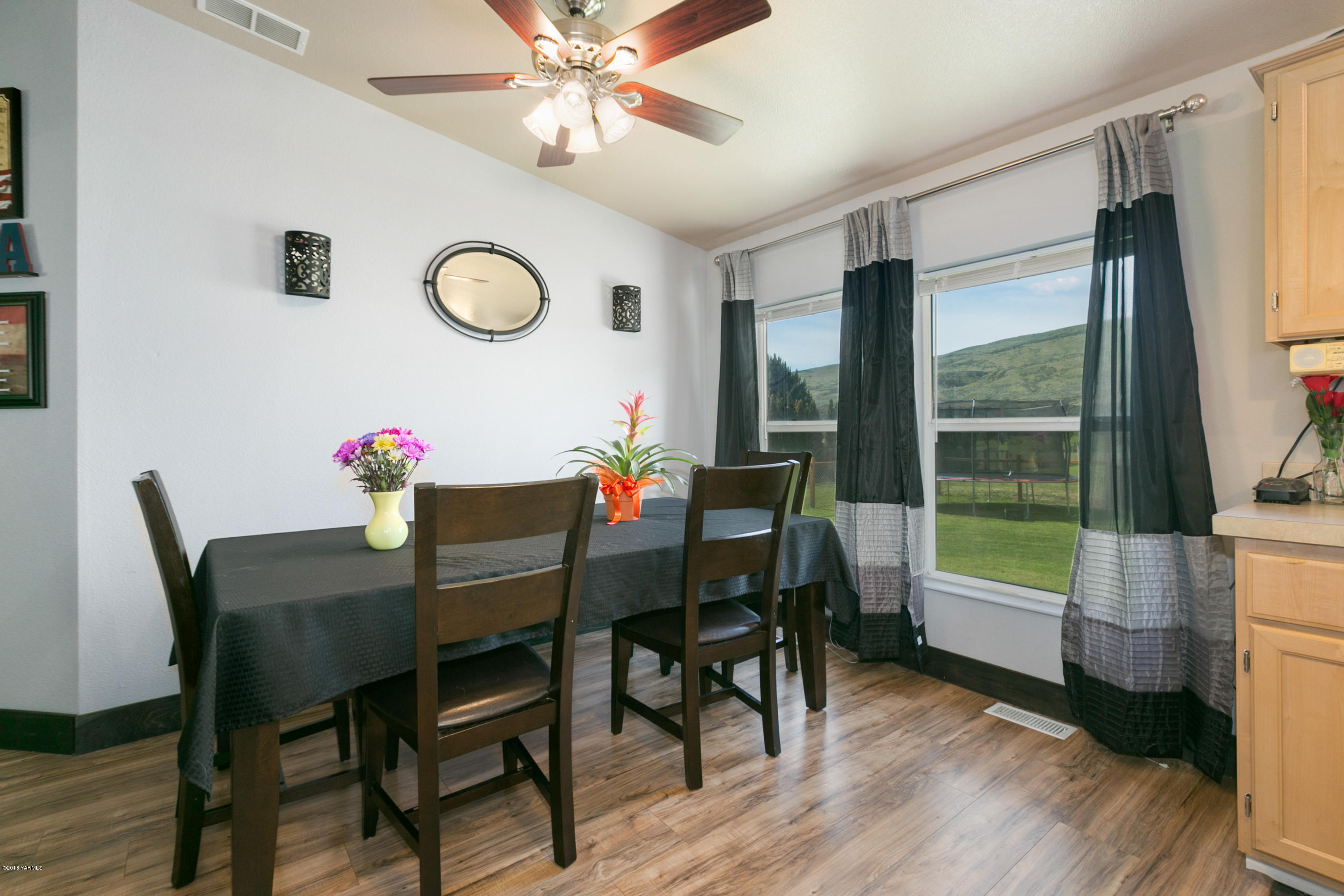 22490 Ahtanum Road Yakima, WA 98903 - Photo 4 of 20 a view of a dining room with furniture window and wooden floor