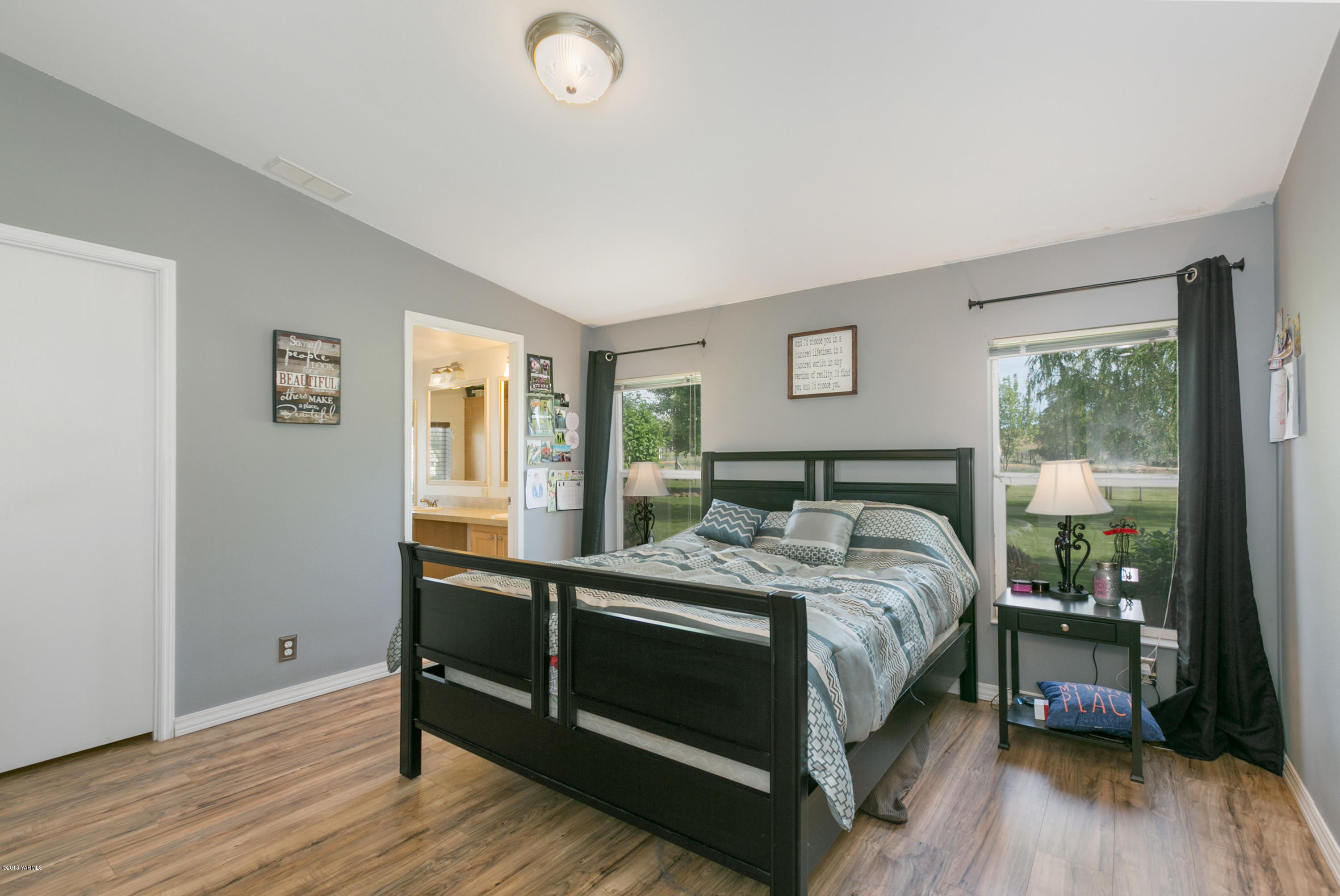 22490 Ahtanum Road Yakima, WA 98903 - Photo 9 of 20 a bed sitting in a bedroom next to a window