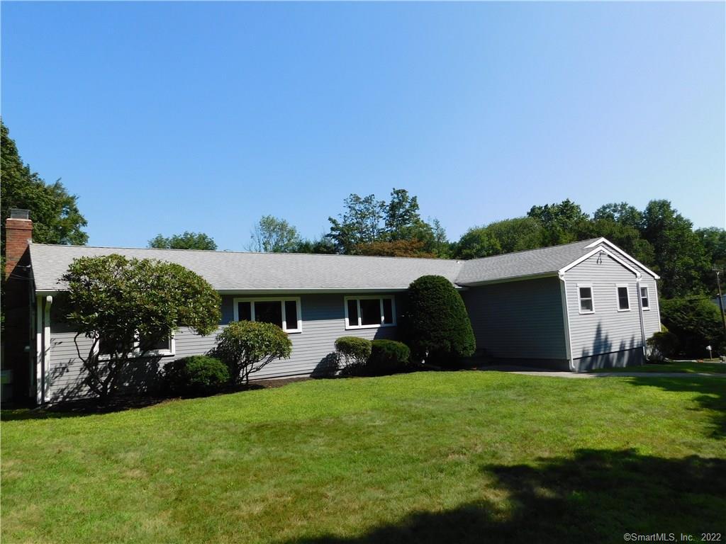 45 Oldfield Road Trumbull, CT 06611 - Photo 1 of 1 a front view of house with yard and outdoor seating