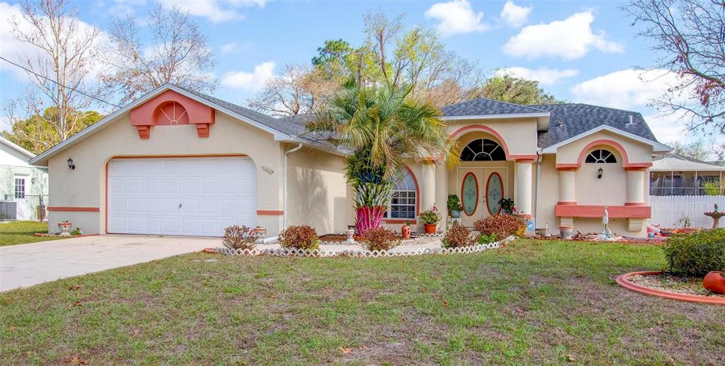 11612 Sheffield Road Spring Hill, FL 34608 - Photo 1 of 1 a front view of house with yard and garage