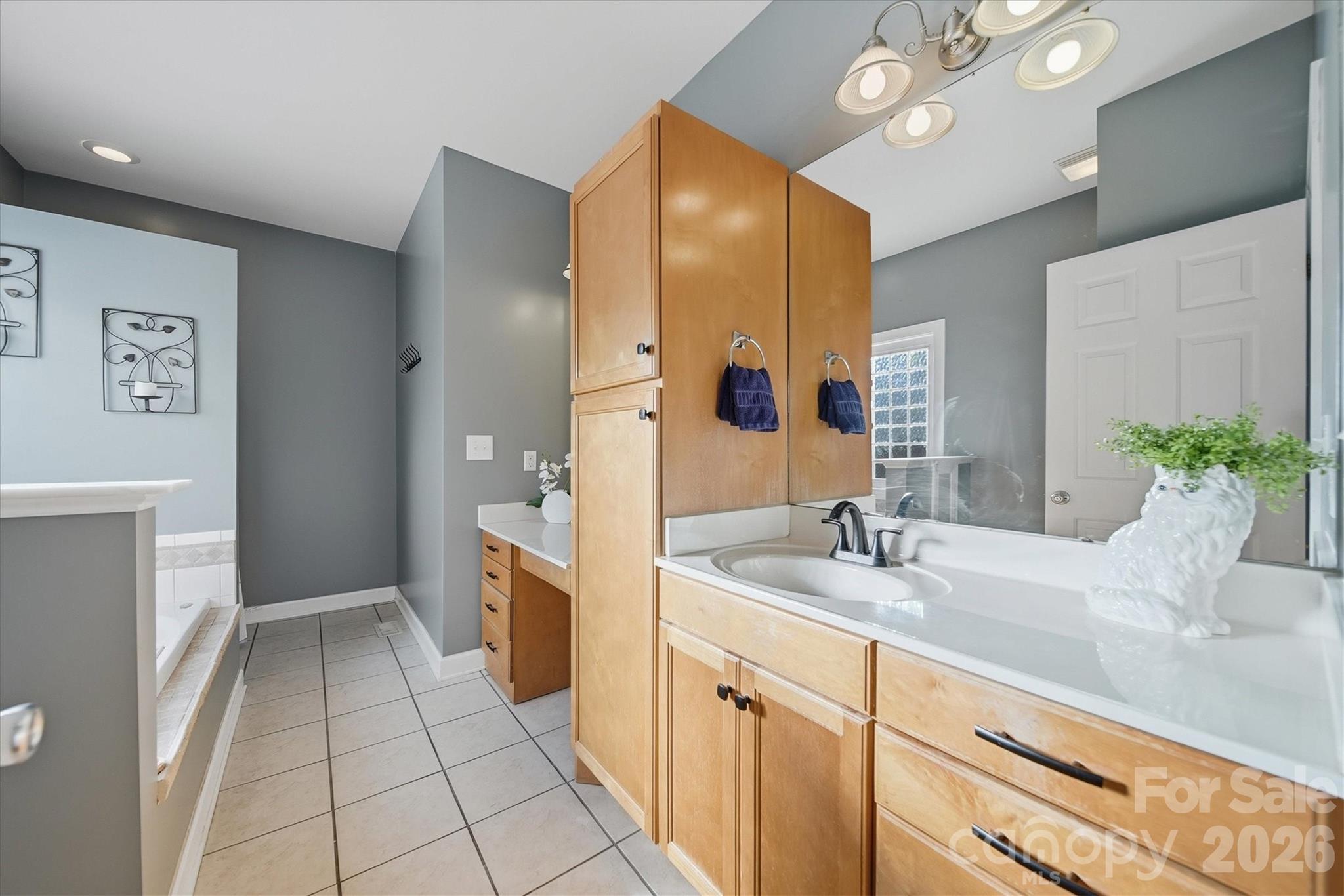 2555 Knox Landing Road Connelly Springs, NC 28612 - Photo 19 of 48 a spacious bathroom with a granite countertop sink and a mirror