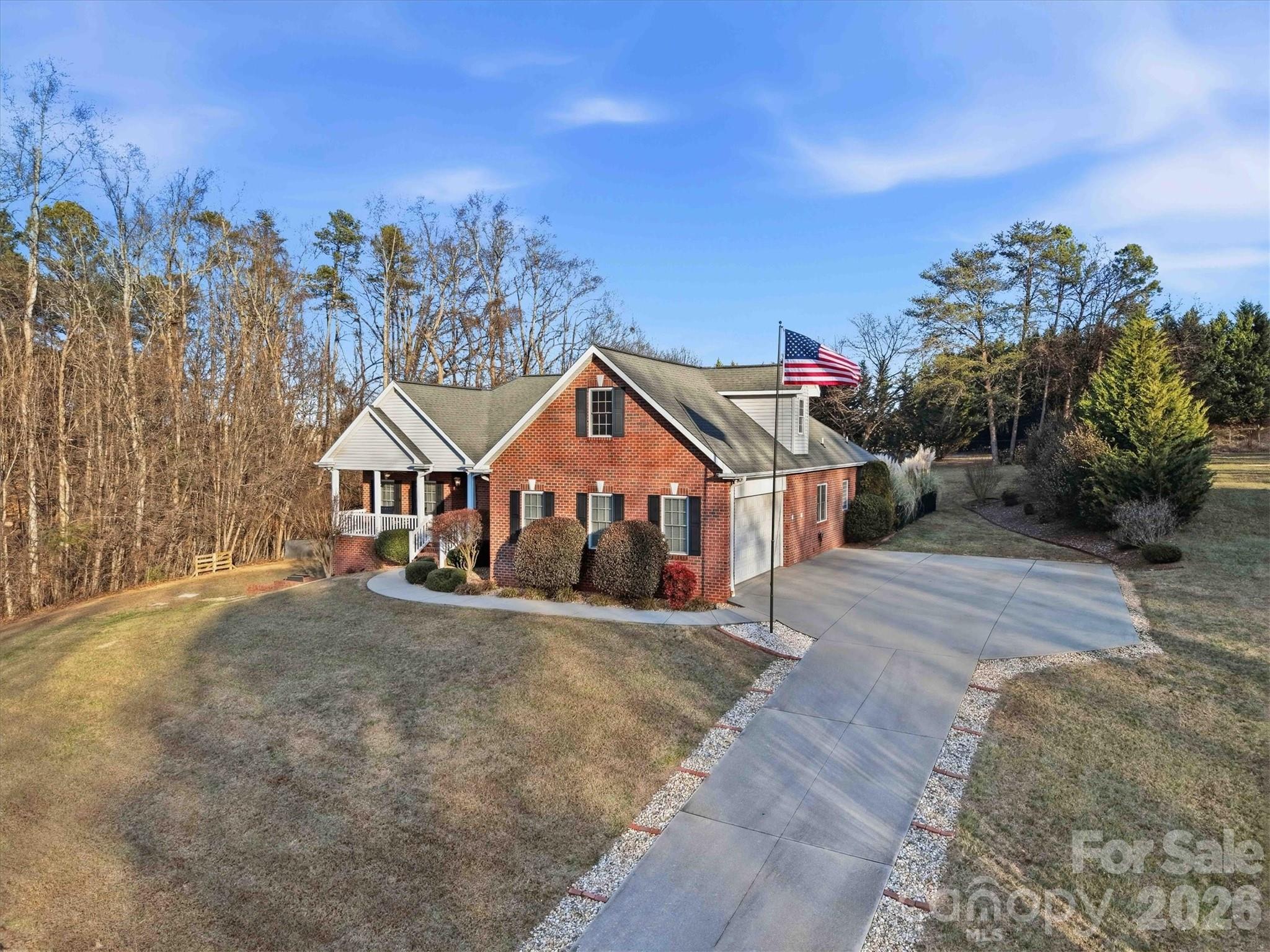 2555 Knox Landing Road Connelly Springs, NC 28612 - Photo 46 of 48 a view of a large house with a big yard and large trees