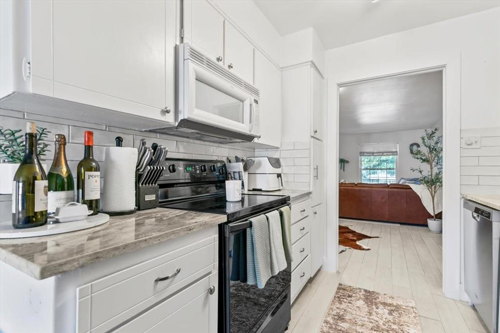 4100 Ridglea Country Club Drive, Unit 1403 Fort Worth, TX 76126 - Photo 7 of 17 a kitchen with stainless steel appliances granite countertop a sink and a stove
