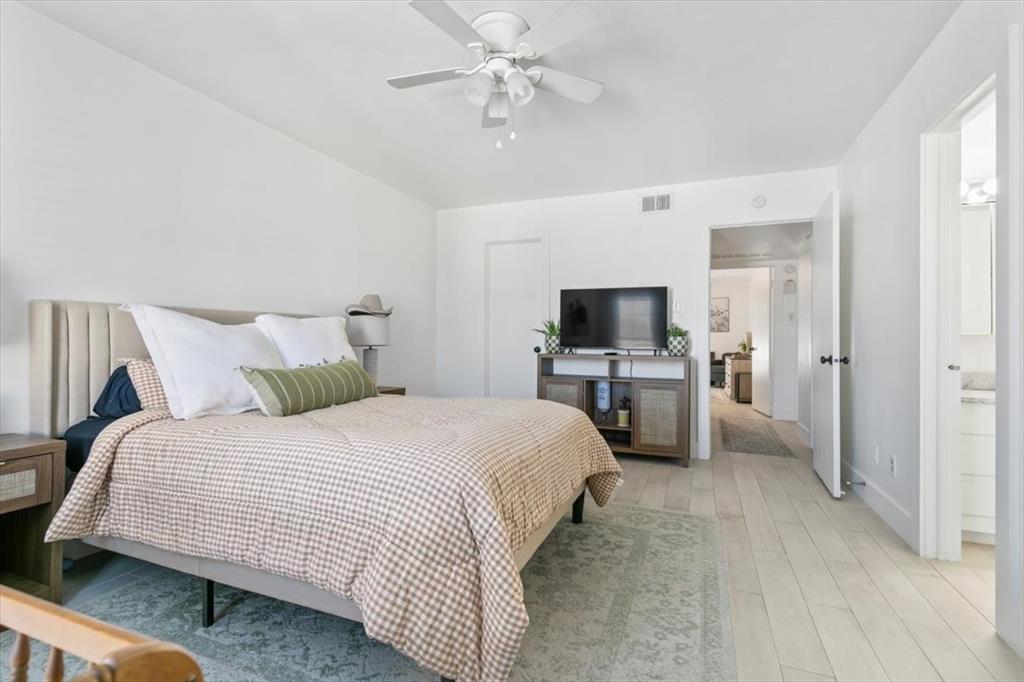 4100 Ridglea Country Club Drive, Unit 1403 Fort Worth, TX 76126 - Photo 10 of 17 a bedroom with a bed and a chandelier