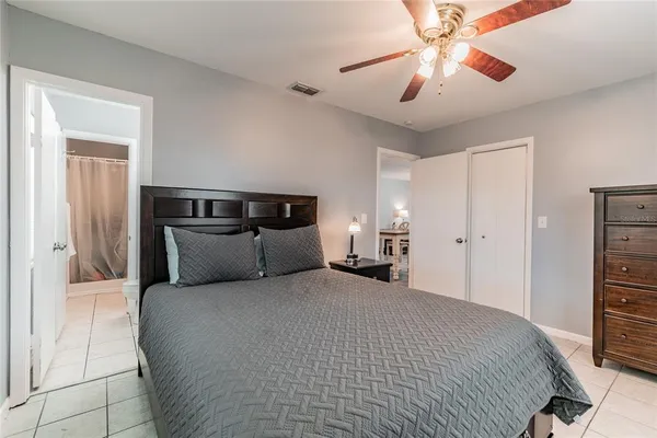 a bedroom with a large bed and a chandelier
