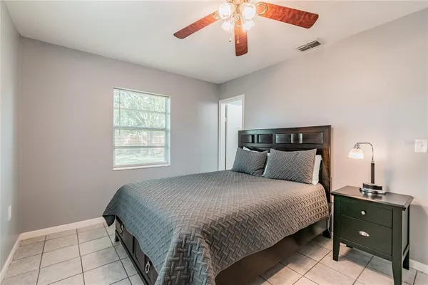 a bedroom with a bed and window