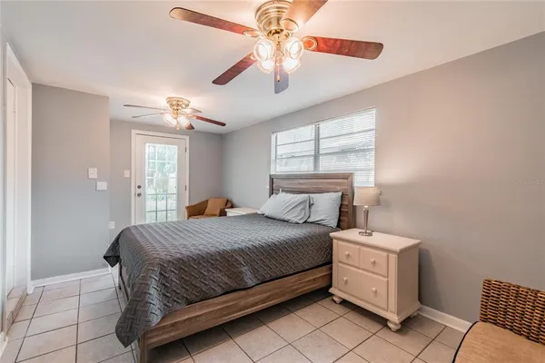 a bedroom with a bed dresser and a window