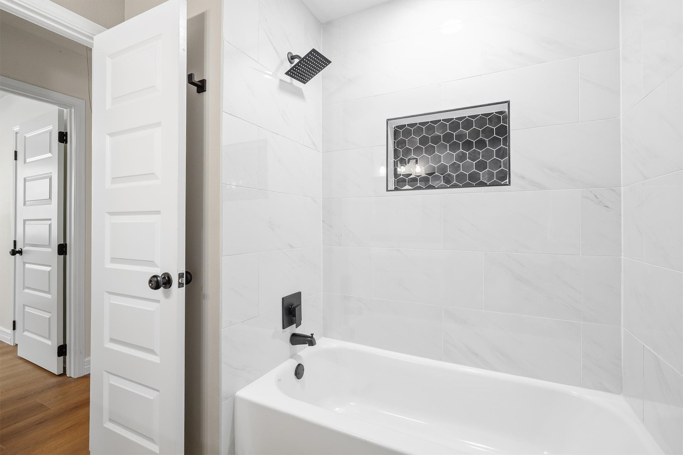 3 Still Corner Place Spring, TX 77381 - Photo 24 of 34 A tub/shower combo finished with marble-look tile and a built-in niche rounds out this bath, functional and stylish all at once.