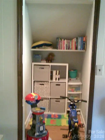 a bathroom with a granite countertop sink a mirror and a toilet