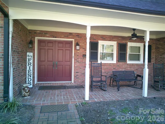 a view of front door of house with outdoor seating