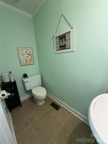 a bathroom with a sink toilet and mirror