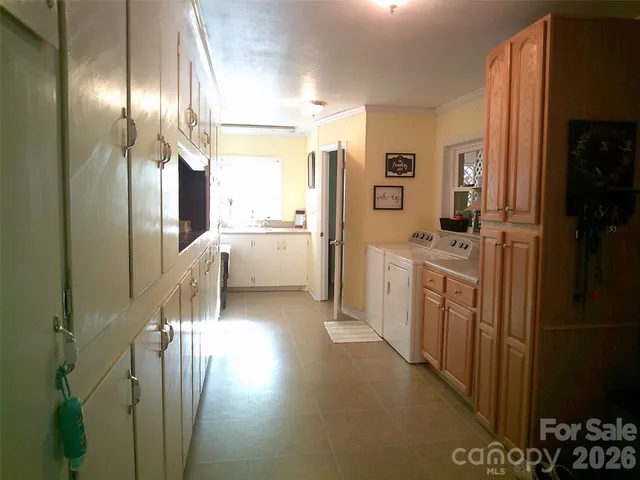 a kitchen with stainless steel appliances kitchen island a sink stove and cabinets