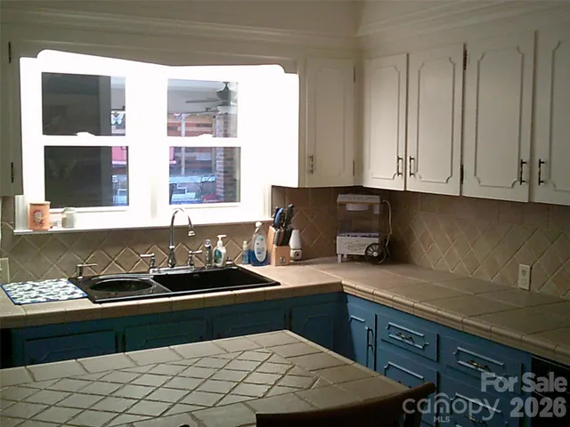 a view of room with cabinets and book shelf