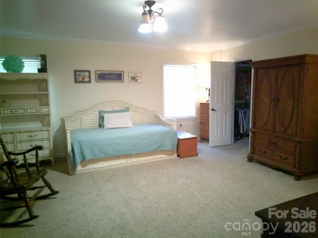 a bedroom with a bed and a couch