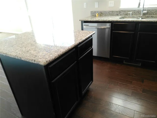 a kitchen with a sink a counter top space and appliances