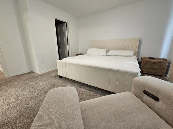 a large white bed in a white room