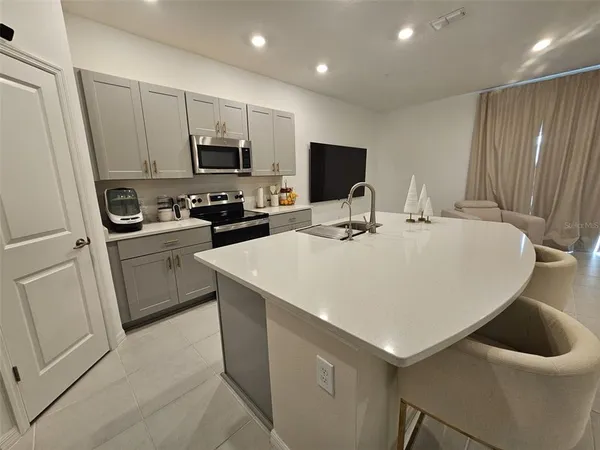 a kitchen with a sink a stove and refrigerator