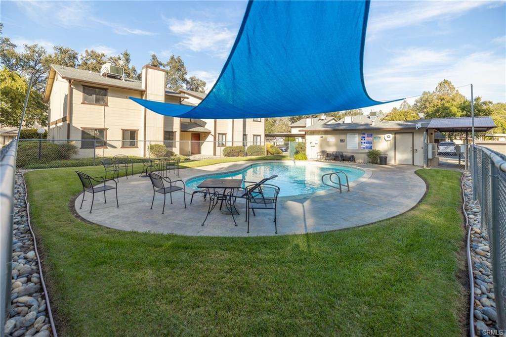 49400 River Park Road, Unit 17 Oakhurst, CA 93644 - Photo 16 of 34 a view of a house with a swimming pool