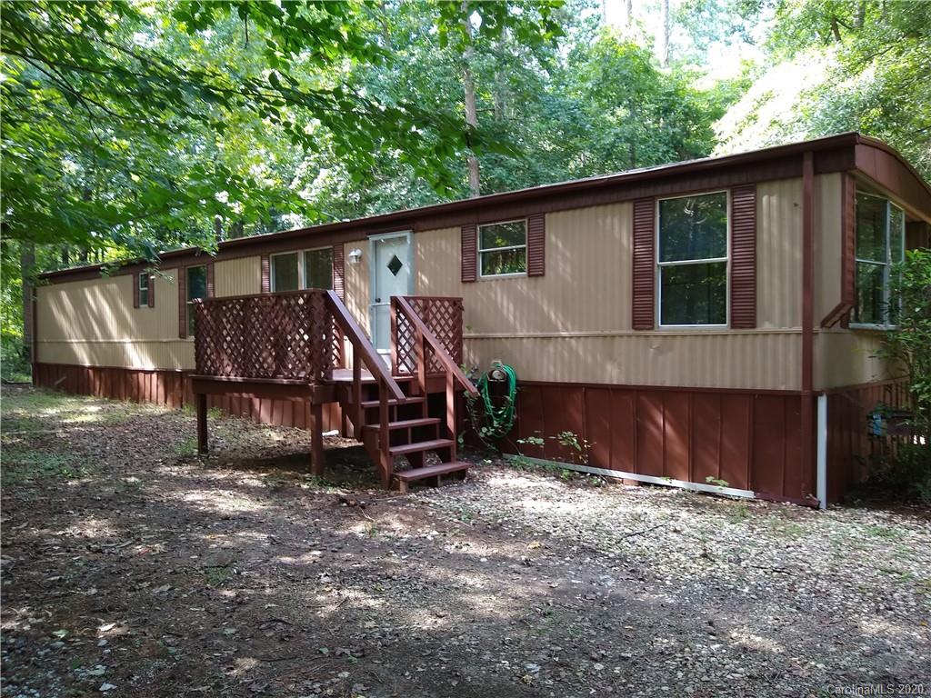 a view of a house with a yard and wooden fence