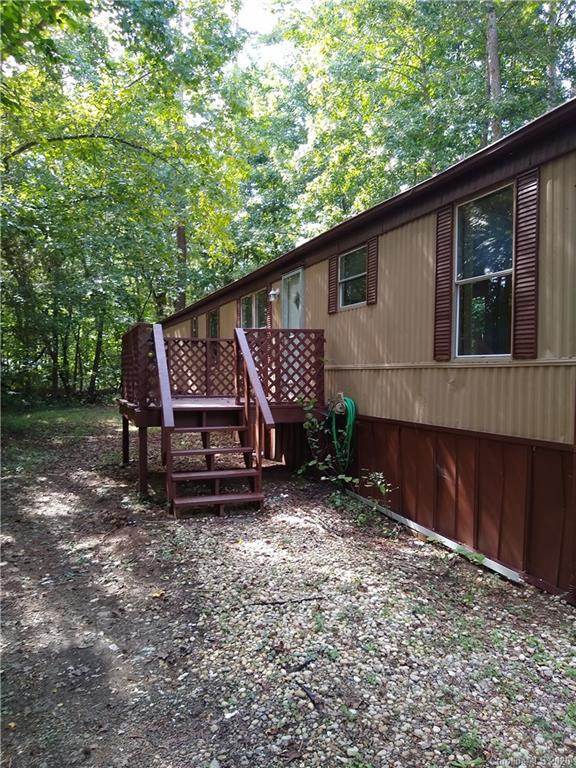 10116 Robert Bost Road Midland, NC 28107 - Photo 2 of 33 a wooden house with trees in front of it