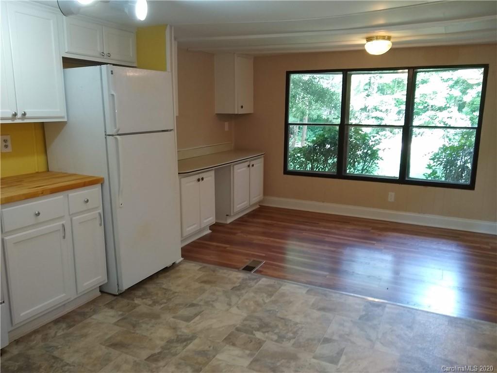 10116 Robert Bost Road Midland, NC 28107 - Photo 11 of 33 a kitchen with a refrigerator a stove top oven and a large window