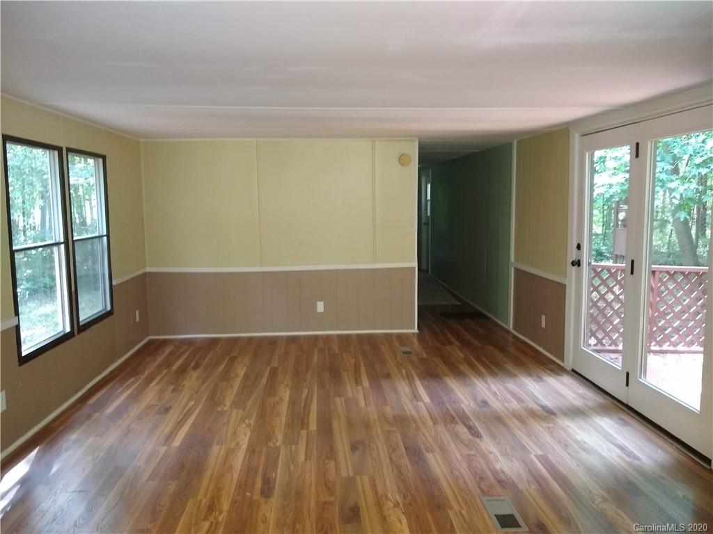 10116 Robert Bost Road Midland, NC 28107 - Photo 15 of 33 an empty room with wooden floor and windows